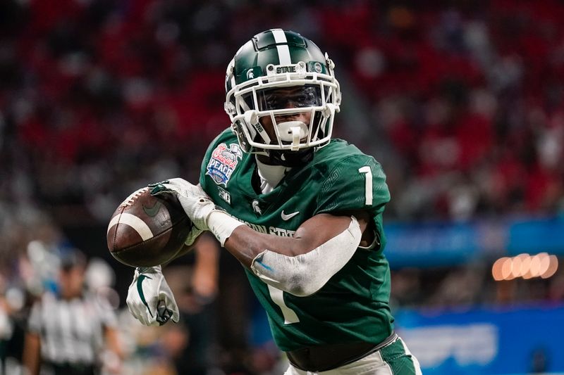 Dec 30, 2021; Atlanta, GA, USA; Michigan State Spartans wide receiver Jayden Reed (1) reacts after catching a touchdown pass against the Pittsburgh Panthers during the first quarter during the 2021 Peach Bowl at Mercedes-Benz Stadium. Mandatory Credit: Dale Zanine-USA TODAY Sports