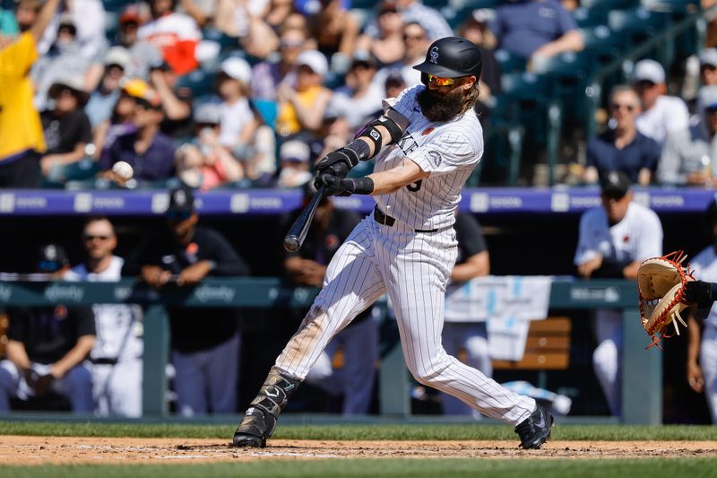 May 27, 2024; Denver, Colorado, USA; Colorado Rockies right fielder Charlie Blackmon (19) hits an RBI double in the sixth inning against the Cleveland Guardians at Coors Field. Mandatory Credit: Isaiah J. Downing-USA TODAY Sports