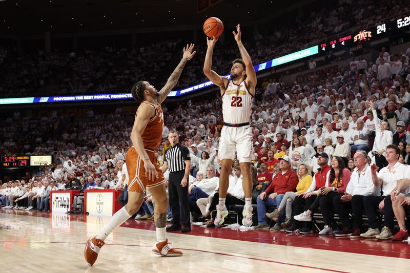 Jan 17, 2023; Ames, Iowa, USA; Iowa State Cyclones guard Gabe Kalscheur (22) shoots over Texas Longhorns forward Timmy Allen (0) in the first half at James H. Hilton Coliseum. Mandatory Credit: Reese Strickland-USA TODAY Sports