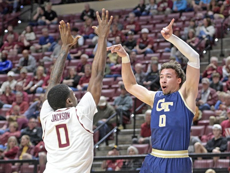 Jan 18, 2025; Tallahassee, Florida, USA;  Georgia Tech Yellowjackets guard Lance Terry (0) passes the ball against Florida State Seminoles guard Chandler Jackson (0) during the first half at Donald L. Tucker Center. Mandatory Credit: Robert Myers-Imagn Images