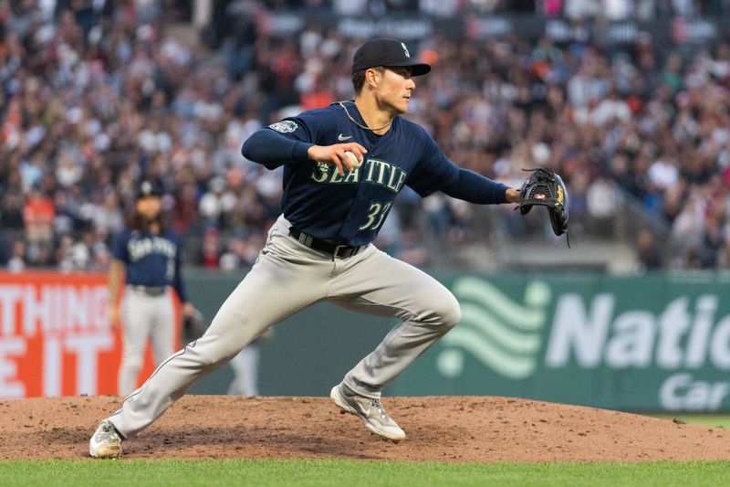 Jul 3, 2023; San Francisco, California, USA;  Seattle Mariners starting pitcher Bryan Woo (33) runs with the ball during the sixth inning against the San Francisco Giants at Oracle Park. Mandatory Credit: Stan Szeto-USA TODAY Sports