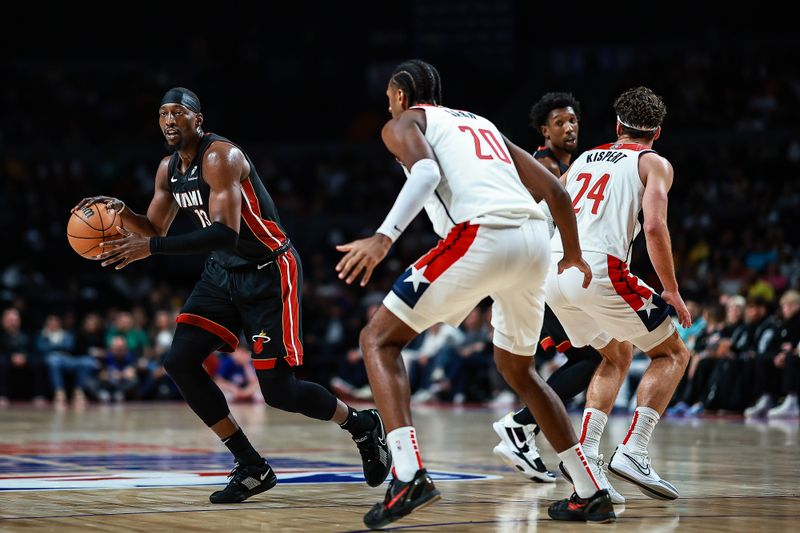 MEXICO CITY, MEXICO - NOVEMBER 02: Bam Adebayo #13 of the Miami Heat drives against Alex Sarr #20 of the Washington Wizards during the second half of the game at Arena Ciudad de Mexico on November 02, 2024 in Mexico City, Mexico. NOTE TO USER: User expressly acknowledges and agrees that, by downloading and or using this photograph, User is consenting to the terms and conditions of the Getty Images License Agreement. (Photo by Manuel Velasquez/Getty Images)