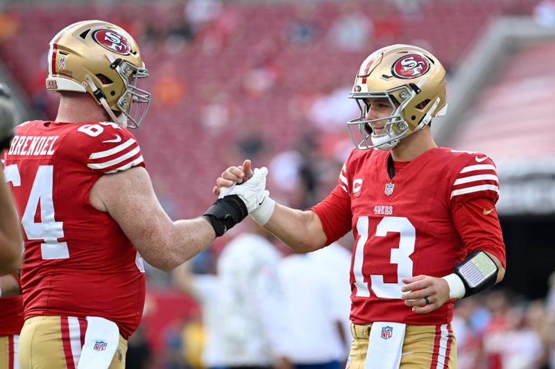 San Francisco 49ers center Jake Brendel, left, and quarterback Brock Purdy warm up before an NFL football game against the Tampa Bay Buccaneers in Tampa, Fla., Sunday, Nov. 10, 2024. (AP Photo/Jason Behnken)