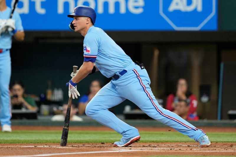 Aug 20, 2023; Arlington, Texas, USA; Texas Rangers shortstop Corey Seager (5) follows through on his single against the Milwaukee Brewers during the first inning at Globe Life Field. Mandatory Credit: Jim Cowsert-USA TODAY Sports