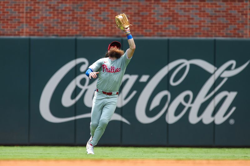 Jul 7, 2024; Atlanta, Georgia, USA; Philadelphia Phillies right fielder Brandon Marsh (16) catches a fly ball against the Atlanta Braves in the first inning at Truist Park. Mandatory Credit: Brett Davis-USA TODAY Sports