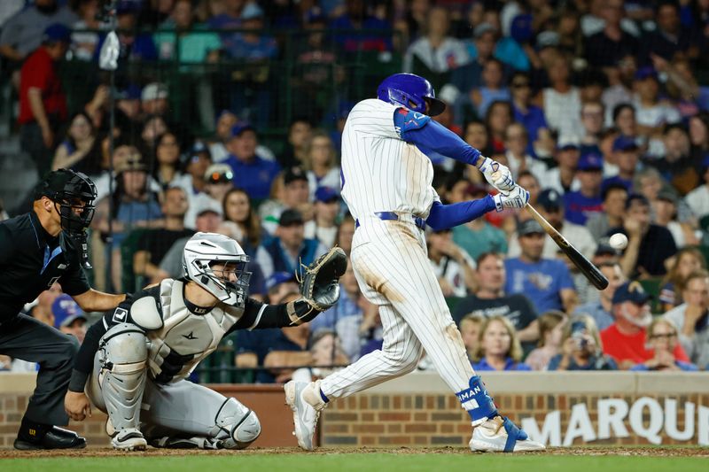 Jun 5, 2024; Chicago, Illinois, USA; Chicago Cubs outfielder Mike Tauchman (40) hits a walk-off home run against the Chicago White Sox during the ninth inning at Wrigley Field. Mandatory Credit: Kamil Krzaczynski-USA TODAY Sports