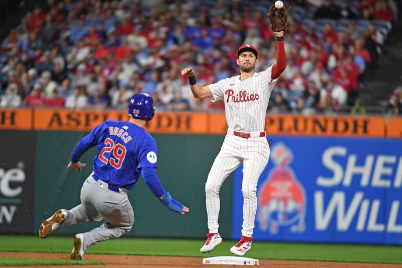 Sep 23, 2024; Philadelphia, Pennsylvania, USA; Philadelphia Phillies shortstop Trea Turner (7) reaches for throw to get force out on Chicago Cubs first base Michael Busch (29) during the fourth inning at Citizens Bank Park. Mandatory Credit: Eric Hartline-Imagn Images