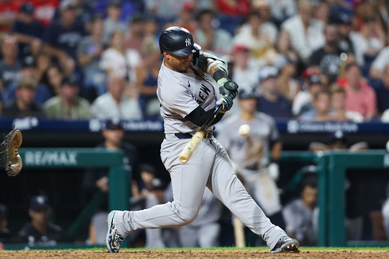 Jul 30, 2024; Philadelphia, Pennsylvania, USA; New York Yankees second base Gleyber Torres (25) hits an RBI fielders choice against the Philadelphia Phillies during the twelfth inning at Citizens Bank Park. Mandatory Credit: Bill Streicher-USA TODAY Sports