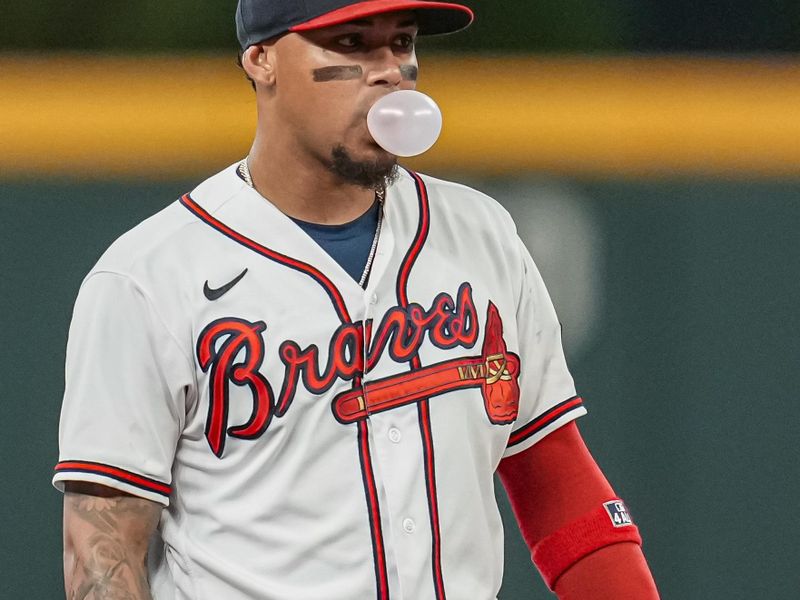 Aug 15, 2023; Cumberland, Georgia, USA; Atlanta Braves shortstop Orlando Arcia (11) blows a bubble while in the field against the New York Yankees during the eighth inning at Truist Park. Mandatory Credit: Dale Zanine-USA TODAY Sports