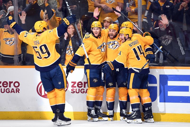 Apr 9, 2024; Nashville, Tennessee, USA; Nashville Predators center Ryan O'Reilly (90) celebrates with teammates after a goal during the third period against the Winnipeg Jets at Bridgestone Arena. Mandatory Credit: Christopher Hanewinckel-USA TODAY Sports