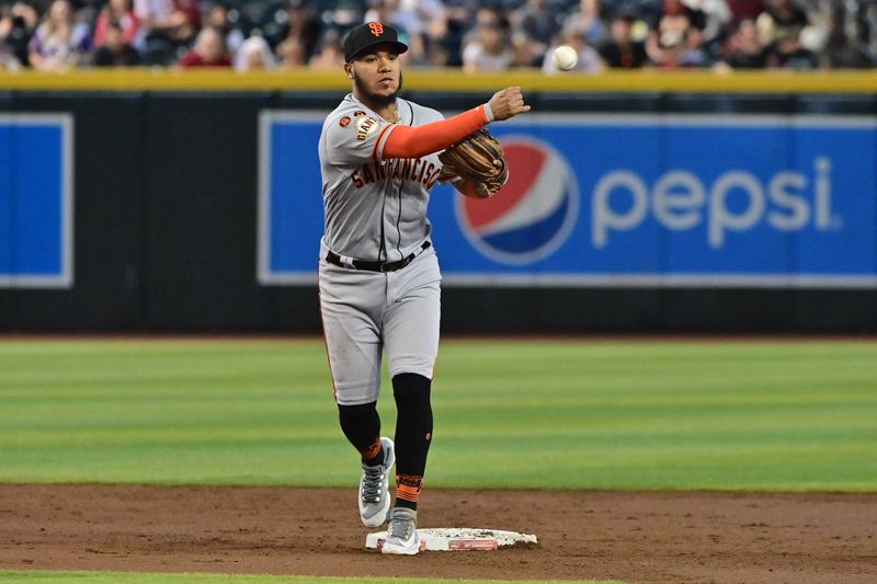 Sep 20, 2023; Phoenix, Arizona, USA;  San Francisco Giants second baseman Thairo Estrada (39) turns a double play in the second inning against the Arizona Diamondbacks at Chase Field. Mandatory Credit: Matt Kartozian-USA TODAY Sports