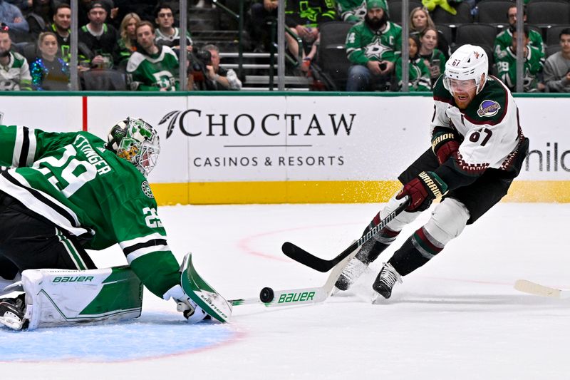 Nov 14, 2023; Dallas, Texas, USA; Arizona Coyotes left wing Lawson Crouse (67) scores a goal against Dallas Stars goaltender Jake Oettinger (29) during the third period at the American Airlines Center. Mandatory Credit: Jerome Miron-USA TODAY Sports