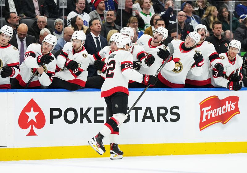 Nov 12, 2024; Toronto, Ontario, CAN; Ottawa Senators right wing Michael Amadio (22) celebrates at the bench after scoring a goal against the Toronto Maple Leafs during the second period at Scotiabank Arena. Mandatory Credit: Nick Turchiaro-Imagn Images