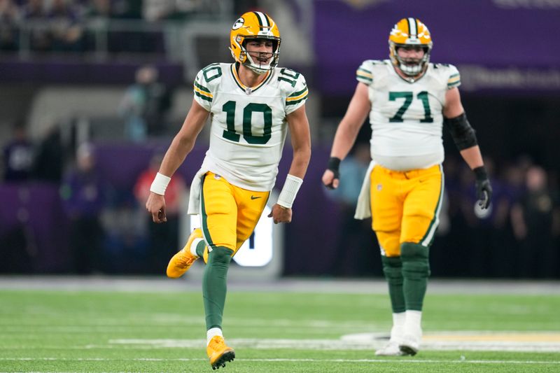 Green Bay Packers' Jordan Love celebrates after throwing a touchdown pass during the first half of an NFL football game against the Minnesota Vikings Sunday, Dec. 31, 2023, in Minneapolis. (AP Photo/Abbie Parr)