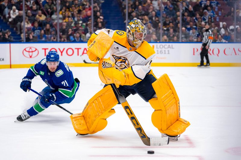 Jan 3, 2025; Vancouver, British Columbia, CAN; Vancouver Canucks forward Nils Hoglander (21) watches Nashville Predators goalie Juuse Saros (74) handle the puck in the second period at Rogers Arena. Mandatory Credit: Bob Frid-Imagn Images