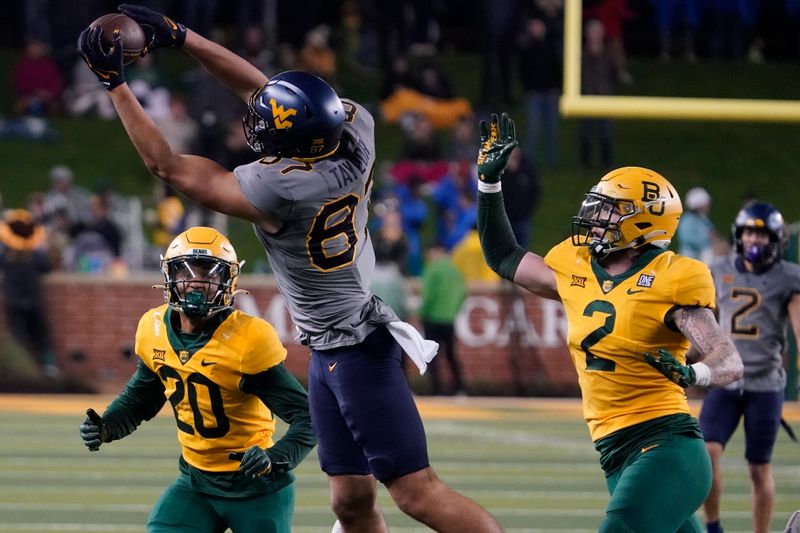 Nov 25, 2023; Waco, Texas, USA; West Virginia Mountaineers tight end Kole Taylor (87) makes the catch over Baylor Bears linebacker Matt Jones (2) safety Devin Lemear (20) during the first half at McLane Stadium. Mandatory Credit: Raymond Carlin III-USA TODAY Sports