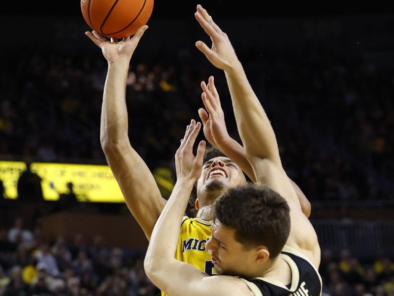 Feb 25, 2024; Ann Arbor, Michigan, USA;  Michigan Wolverines forward Terrance Williams II (5) shoots on Purdue Boilermakers forward Camden Heide (23) in the first half at Crisler Center. Mandatory Credit: Rick Osentoski-USA TODAY Sports