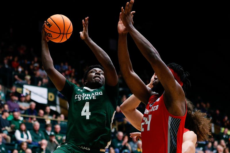 Mar 3, 2023; Fort Collins, Colorado, USA; Colorado State Rams guard Isaiah Stevens (4) drives to the net against New Mexico Lobos forward Morris Udeze (24) in the second half at Moby Arena. Mandatory Credit: Isaiah J. Downing-USA TODAY Sports