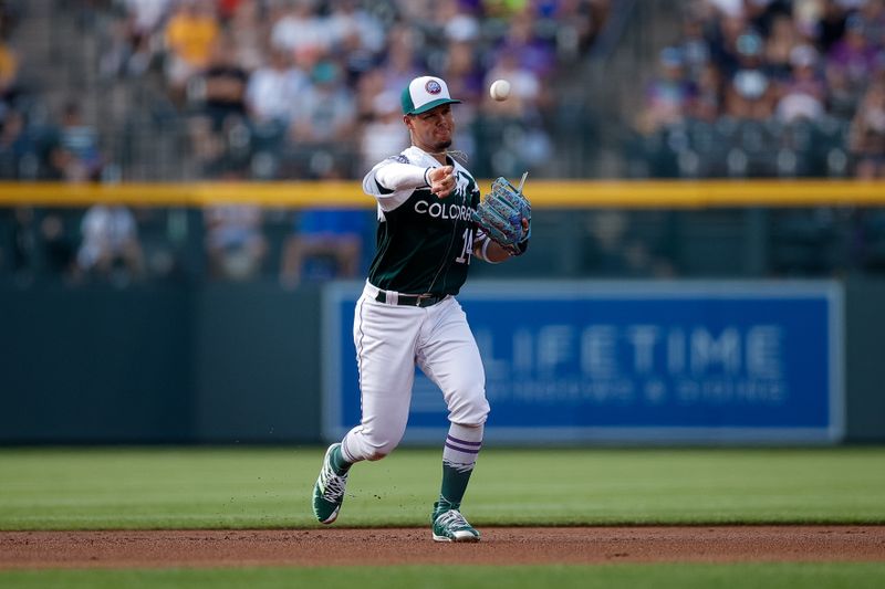 Jul 15, 2023; Denver, Colorado, USA; Colorado Rockies shortstop Ezequiel Tovar (14) makes a throw to first for an out in the first inning against the New York Yankees at Coors Field. Mandatory Credit: Isaiah J. Downing-USA TODAY Sports