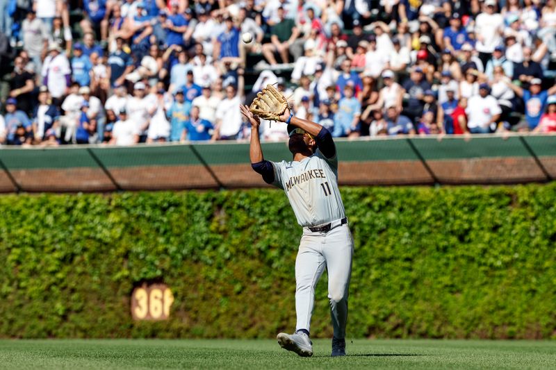 May 3, 2024; Chicago, Illinois, USA; Milwaukee Brewers outfielder Jackson Chourio (11) catches a fly ball hit by Chicago Cubs shortstop Dansby Swanson for the final out of the game during the ninth inning at Wrigley Field. Mandatory Credit: Kamil Krzaczynski-USA TODAY Sports