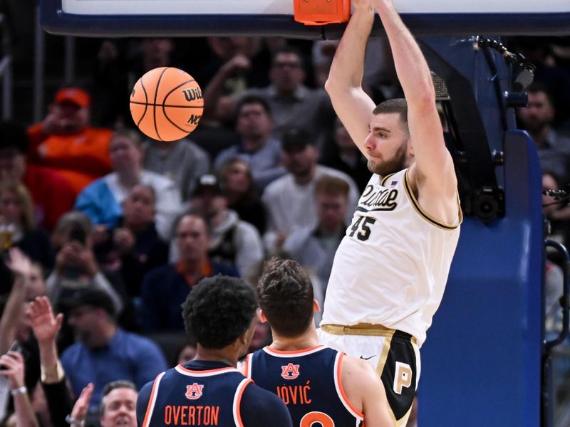 Dec 20, 2025; Indianapolis, Indiana, USA; Purdue Boilermakers center Oscar Cluff (45) dunks the ball past Auburn Tigers forward Filip Jovic (38) during the first half at Gainbridge Fieldhouse. Mandatory Credit: Robert Goddin-Imagn Images