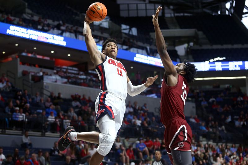 Feb 11, 2023; Oxford, Mississippi, USA; Mississippi Rebels guard Matthew Murrell (11) drives to the basket as South Carolina Gamecocks forward Josh Gray (33) defends during the second half at The Sandy and John Black Pavilion at Ole Miss. Mandatory Credit: Petre Thomas-USA TODAY Sports