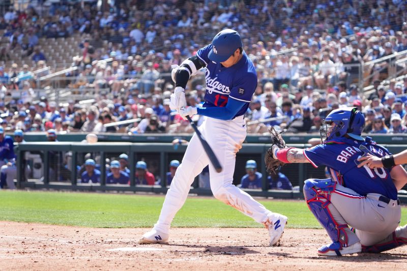 Mar 6, 2025; Phoenix, Arizona, USA; Los Angeles Dodgers two-way player Shohei Ohtani (17) bats against the Texas Rangers during the third inning at Camelback Ranch-Glendale. Mandatory Credit: Joe Camporeale-Imagn Images