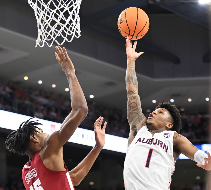 Feb 11, 2023; Auburn, Alabama, USA;  Alabama Crimson Tide forward Noah Clowney (15) defends a shot by Auburn Tigers guard Wendell Green Jr. (1) at Neville Arena. Mandatory Credit: Julie Bennett-USA TODAY Sports