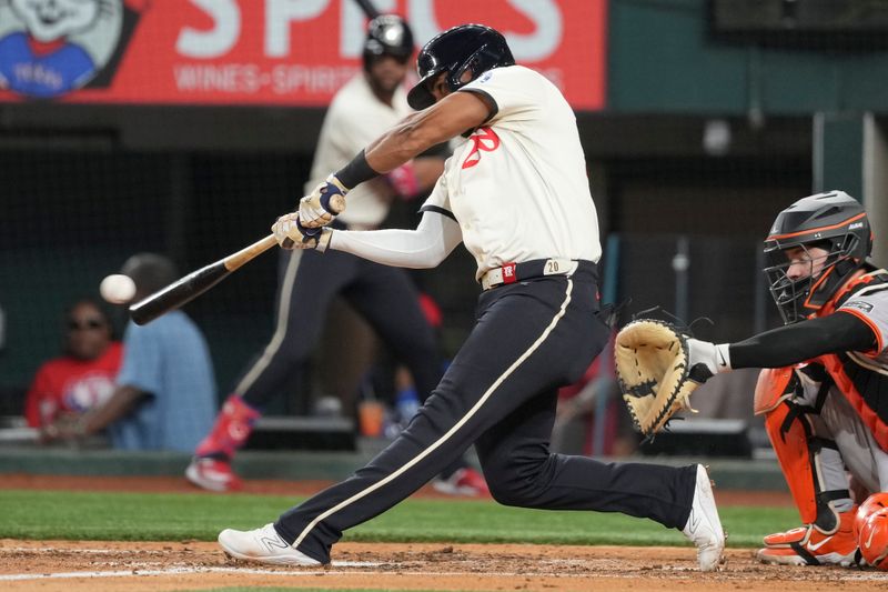 Jun 7, 2024; Arlington, Texas, USA; Texas Rangers third baseman Ezequiel Duran hits an RBI single against the San Francisco Giants during the fifth inning at Globe Life Field. Mandatory Credit: Jim Cowsert-USA TODAY Sports