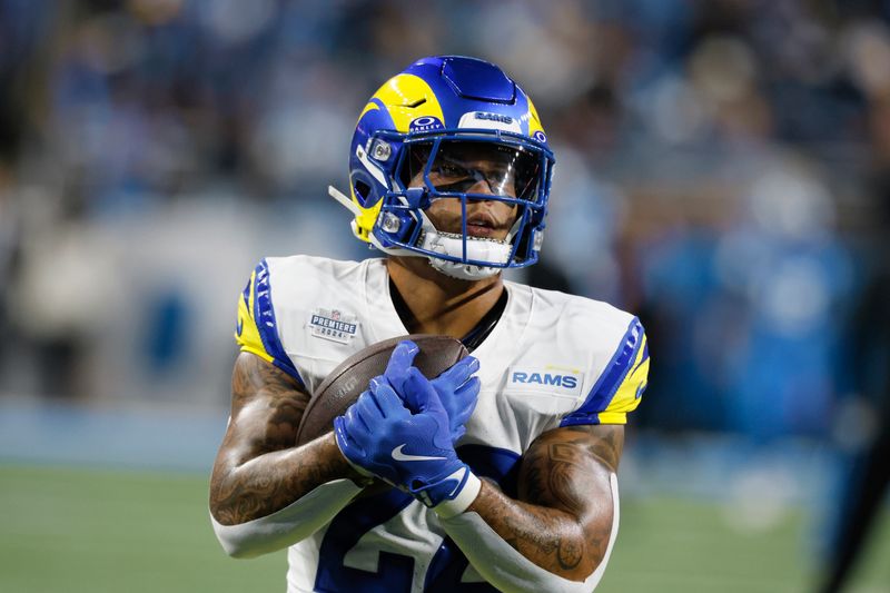 Los Angeles Rams running back Blake Corum runs the ball during warmups before an NFL football game against the Detroit Lions in Detroit, Sunday, Sept. 8, 2024. (AP Photo/Duane Burleson)