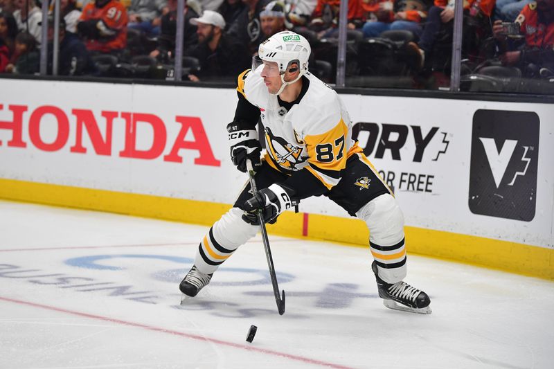 Oct 14, 2025; Anaheim, California, USA; Pittsburgh Penguins center Sidney Crosby (87) controls the puck against the Anaheim Ducks during the third period at Honda Center. Mandatory Credit: Gary A. Vasquez-Imagn Images