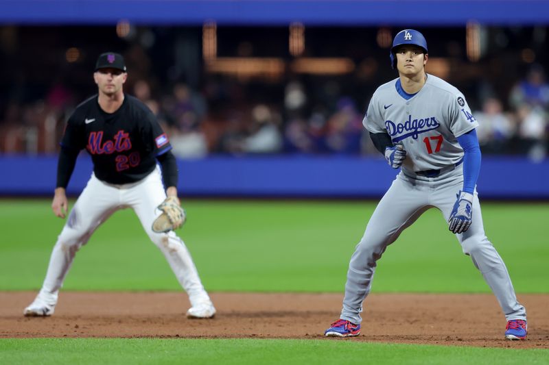 May 23, 2025; New York City, New York, USA; Los Angeles Dodgers designated hitter Shohei Ohtani (17) leads off first base in front of New York Mets first baseman Pete Alonso (20) during the third inning at Citi Field. Mandatory Credit: Brad Penner-Imagn Images