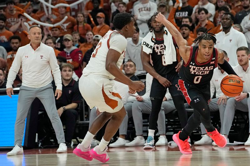 Jan 6, 2024; Austin, Texas, USA; Texas Tech Red Raiders guard Chance McMillian (0) drives to the basket while defended by Texas Longhorns guard Max Abmas (3) during the second half at Moody Center. Mandatory Credit: Scott Wachter-USA TODAY Sports