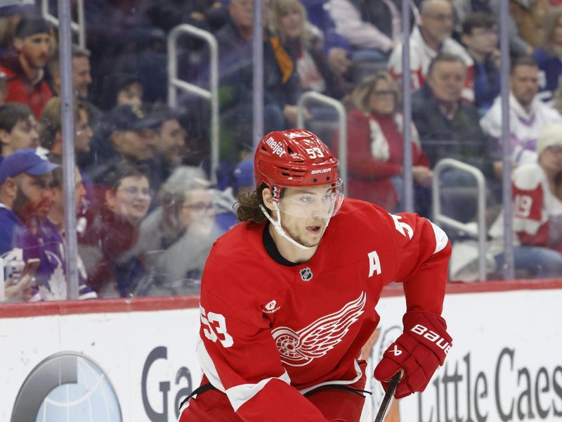 Dec 14, 2024; Detroit, Michigan, USA;  Detroit Red Wings defenseman Moritz Seider (53) skates with the puck in the first period against the Toronto Maple Leafs at Little Caesars Arena. Mandatory Credit: Rick Osentoski-Imagn Images