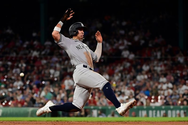 Sep 12, 2023; Boston, Massachusetts, USA; New York Yankees right fielder Oswaldo Cabrera (95) slides into third base during the ninth inning against the Boston Red Sox at Fenway Park. Mandatory Credit: Eric Canha-USA TODAY Sports