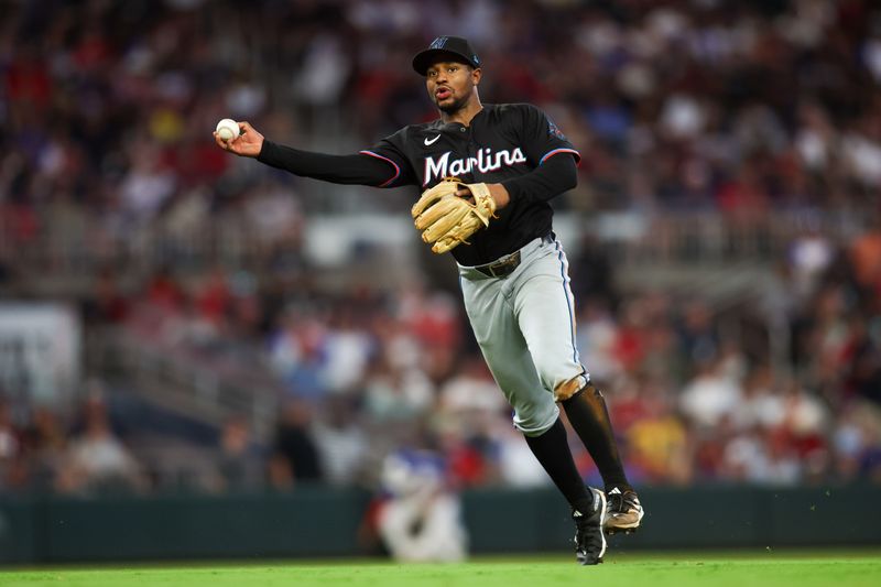 Aug 3, 2024; Atlanta, Georgia, USA; Miami Marlins shortstop Xavier Edwards (63) throws a runner out at first against the Atlanta Braves in the fifth inning at Truist Park. Mandatory Credit: Brett Davis-USA TODAY Sports