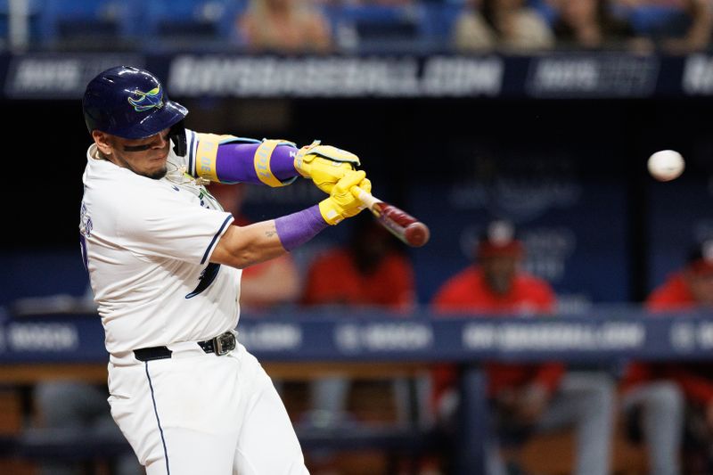 Jun 28, 2024; St. Petersburg, Florida, USA;  Tampa Bay Rays third base Isaac Paredes (17) hits a rbi single against the Washington Nationals in the third inning at Tropicana Field. Mandatory Credit: Nathan Ray Seebeck-USA TODAY Sports