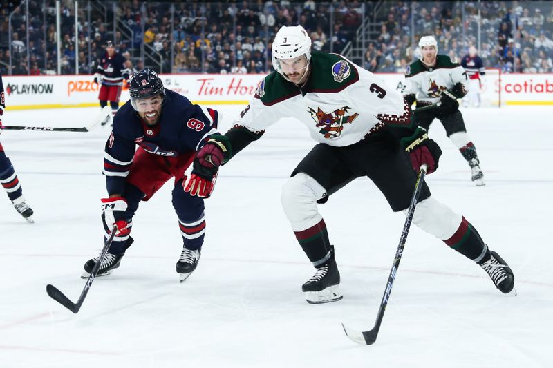 Nov 18, 2023; Winnipeg, Manitoba, CAN;  Arizona Coyotes defenseman Josh Brown (3)) and Winnipeg Jets forward Alex Iafallo (9) chase after the puck during the second period at Canada Life Centre. Mandatory Credit: Terrence Lee-USA TODAY Sports