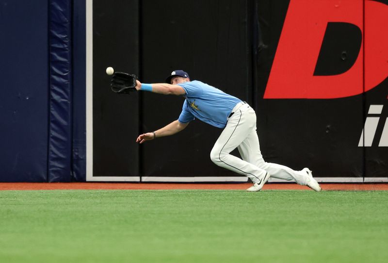 May 28, 2023; St. Petersburg, Florida, USA;Tampa Bay Rays right fielder Luke Raley (55) catches a fly ball against the Los Angeles Dodgers during the first inning at Tropicana Field. Mandatory Credit: Kim Klement-USA TODAY Sports