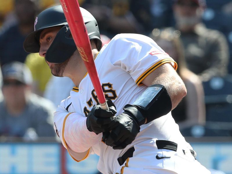 May 11, 2025; Pittsburgh, Pennsylvania, USA;  Pittsburgh Pirates catcher Joey Bart (14) drives in the game winning run against the Atlanta Braves during the ninth inning at PNC Park. Mandatory Credit: Charles LeClaire-Imagn Images