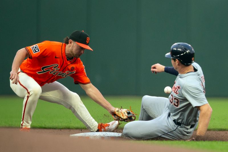 Aug 9, 2024; San Francisco, California, USA; San Francisco Giants second baseman Brett Wisely (0) cannot handle the throw from catcher as Detroit Tigers second baseman Colt Keith (33) steals second and then advances to third base on the throwing error during the first inning at Oracle Park. Mandatory Credit: D. Ross Cameron-USA TODAY Sports