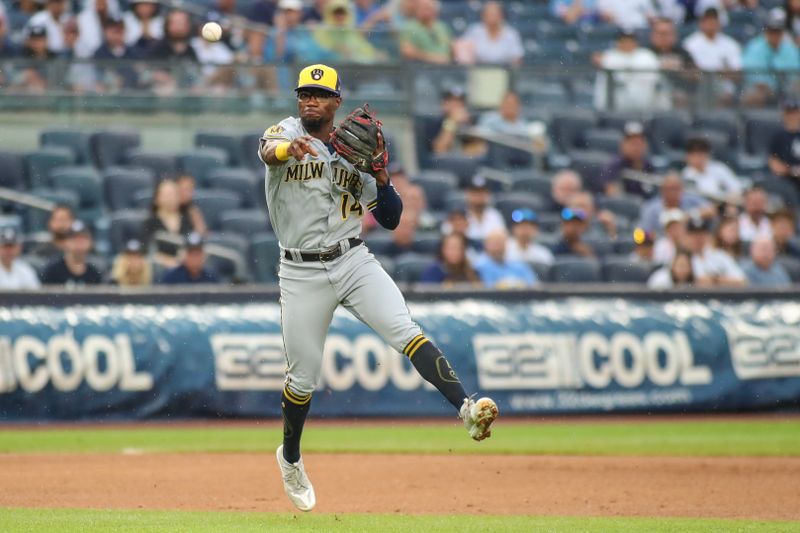 Sep 9, 2023; Bronx, New York, USA;  Milwaukee Brewers right fielder Andruw Monasterio (14) makes a running throw to first base in the first inning against the New York Yankees at Yankee Stadium. Mandatory Credit: Wendell Cruz-USA TODAY Sports