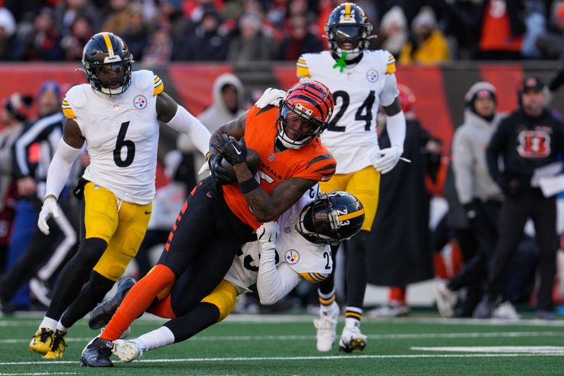 Pittsburgh Steelers safety Damontae Kazee (23) tackles Cincinnati Bengals wide receiver Tee Higgins, center top, during the second half of an NFL football game Sunday, Dec. 1, 2024, in Cincinnati. (AP Photo/Jeff Dean)