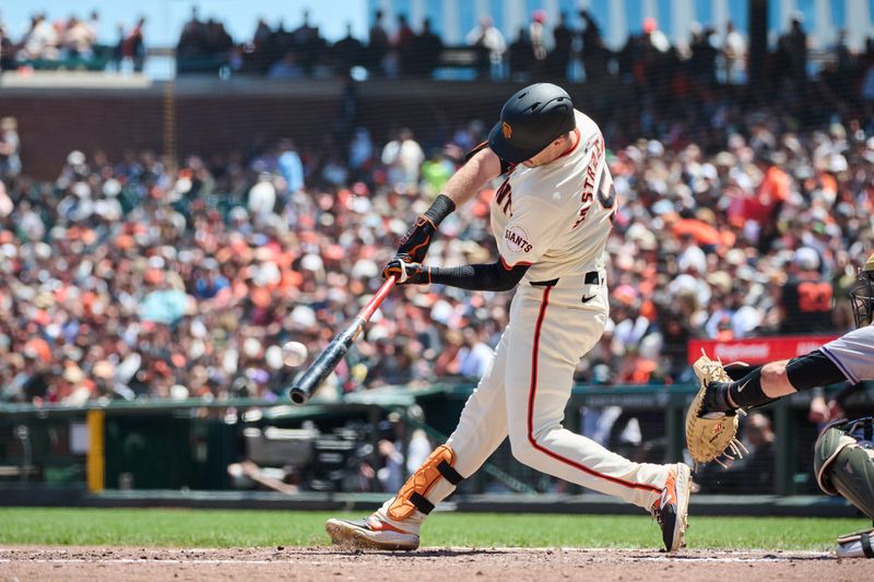 May 19, 2024; San Francisco, California, USA; San Francisco Giants outfielder Mike Yastrzemski (5) hits a single against the Colorado Rockies during the fourth inning at Oracle Park. Mandatory Credit: Robert Edwards-USA TODAY Sports