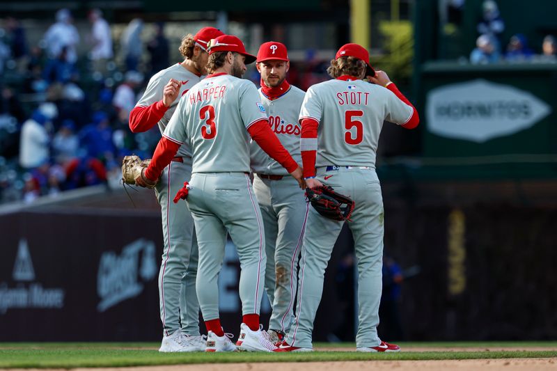 Apr 26, 2025; Chicago, Illinois, USA; Philadelphia Phillies players celebrate after defeating the Chicago Cubs in a baseball game at Wrigley Field. Mandatory Credit: Kamil Krzaczynski-Imagn Images