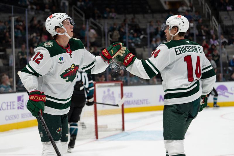 Nov 7, 2024; San Jose, California, USA;  Minnesota Wild left wing Matt Boldy (12) celebrates with center Joel Eriksson Ek (14) during the third period against the San Jose Sharks at SAP Center at San Jose. Mandatory Credit: Stan Szeto-Imagn Images