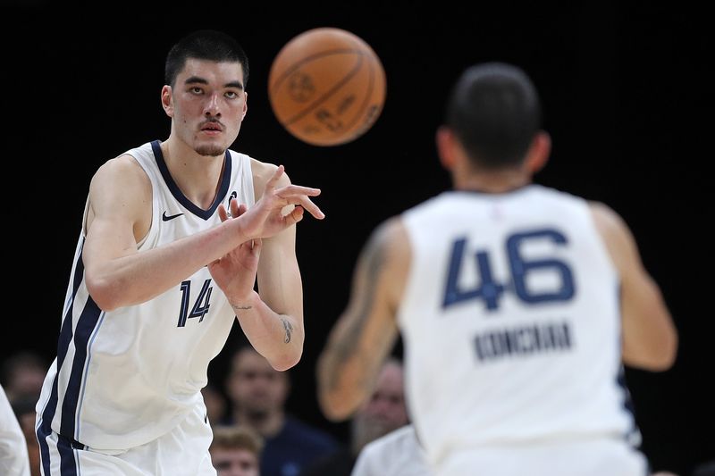 MEMPHIS, TENNESSEE - OCTOBER 10: Zach Edey #14 of the Memphis Grizzlies passes the ball during the first half against the Charlotte Hornets at FedExForum on October 10, 2024 in Memphis, Tennessee. NOTE TO USER: User expressly acknowledges and agrees that, by downloading and or using this photograph, User is consenting to the terms and conditions of the Getty Images License Agreement. (Photo by Justin Ford/Getty Images)