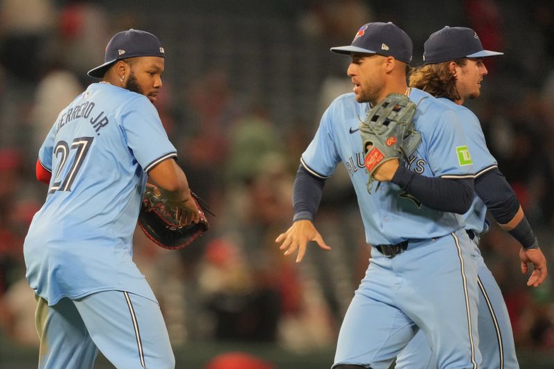 Aug 14, 2024; Anaheim, California, USA; Toronto Blue Jays first baseman Vladimir Guerrero Jr. (27) celebrates with right fielder George Springer (4) after the game against the Los Angeles Angels at Angel Stadium. Mandatory Credit: Kirby Lee-USA TODAY Sports