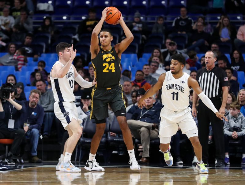 Jan 1, 2023; University Park, Pennsylvania, USA; Iowa Hawkeyes forward Kris Murray (24) holds the ball as Penn State Nittany Lions guard Andrew Funk (10) defends during the first half at Bryce Jordan Center. Penn State defeated Iowa 83-79. Mandatory Credit: Matthew OHaren-USA TODAY Sports