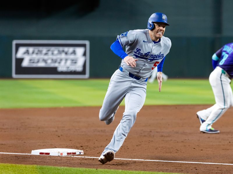 May 9, 2025; Phoenix, Arizona, USA; Los Angeles Dodgers first baseman Freddie Freeman scores in the third inning against the Arizona Diamondbacks at Chase Field. Mandatory Credit: Mark J. Rebilas-Imagn Images